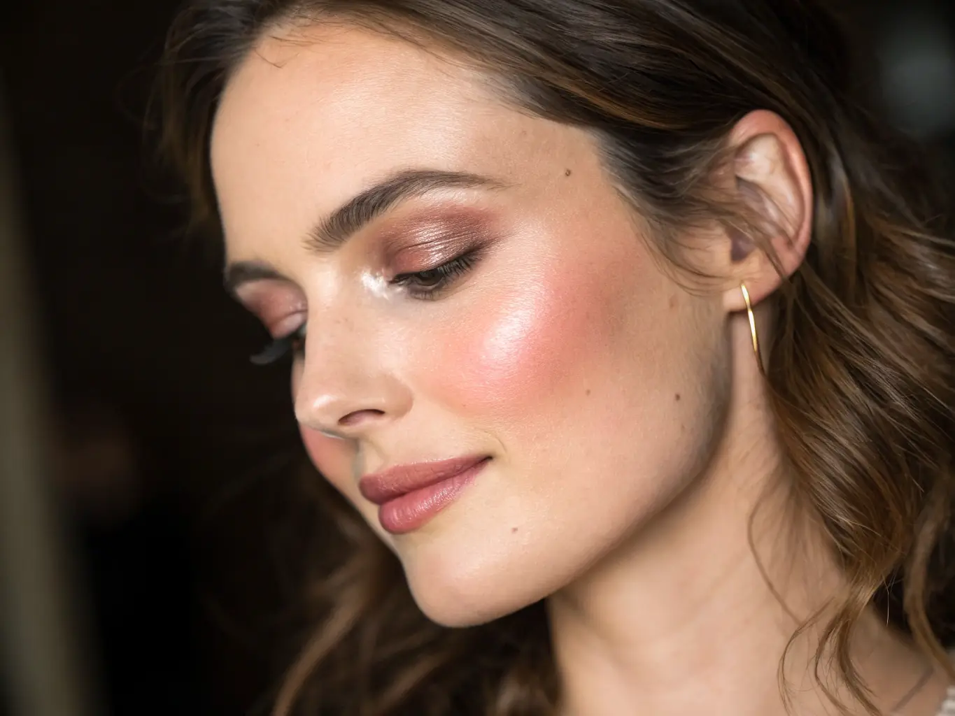 A woman with glowing skin after using a new skincare product, emphasizing the importance of a good skincare routine. The image highlights the product's texture and the skin's luminosity.